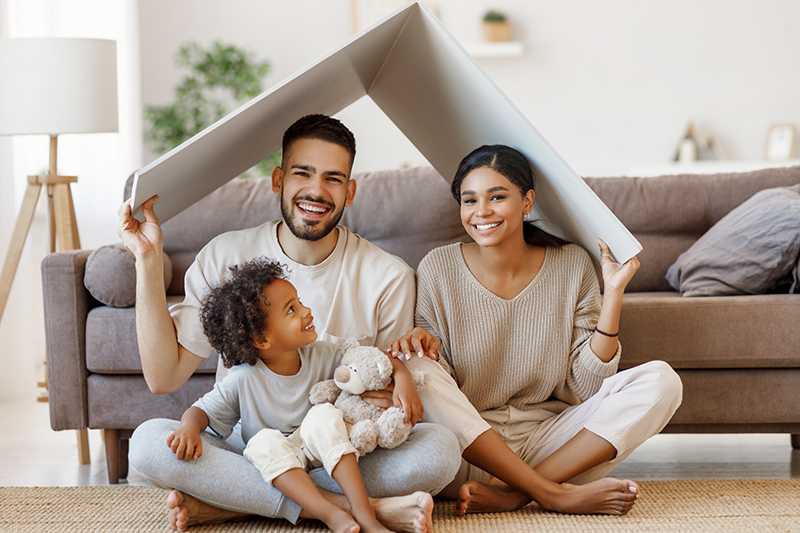 Happy family of three in the new house after a home inspection 